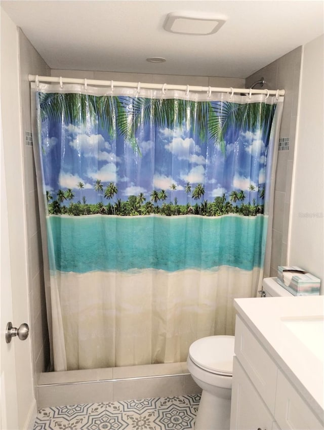 bathroom featuring curtained shower, vanity, and toilet