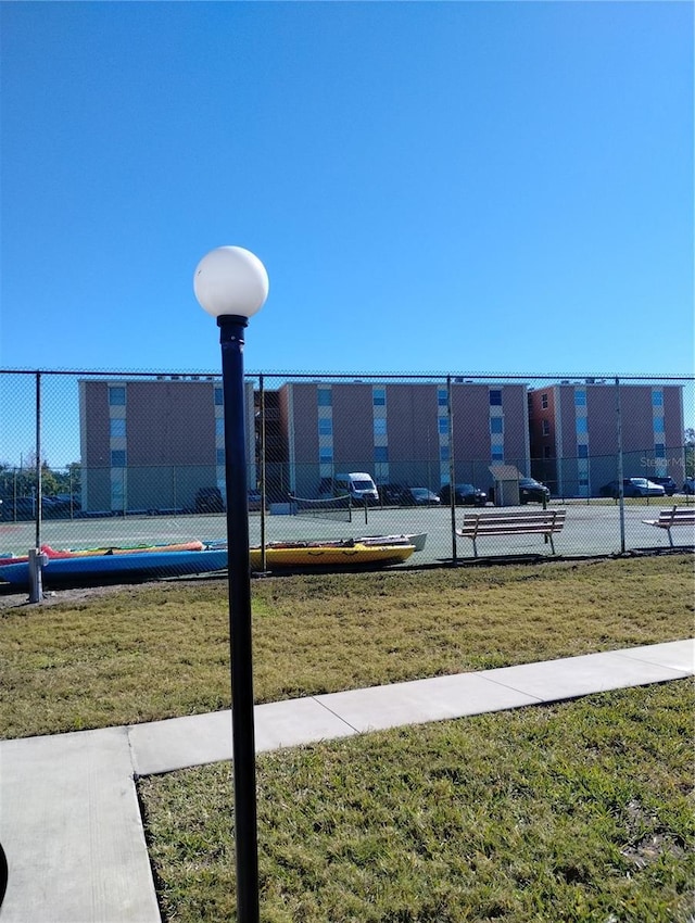 view of home's community featuring a yard and fence