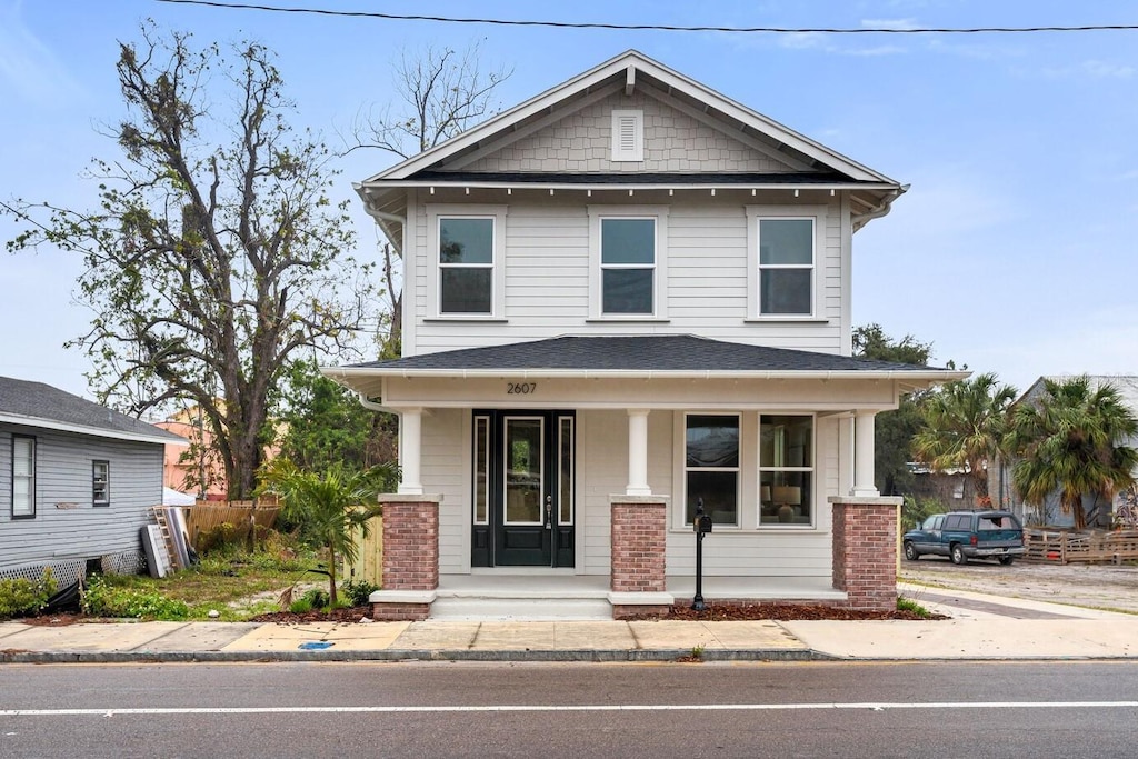 american foursquare style home featuring a porch