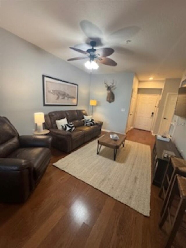 living area with ceiling fan and wood finished floors