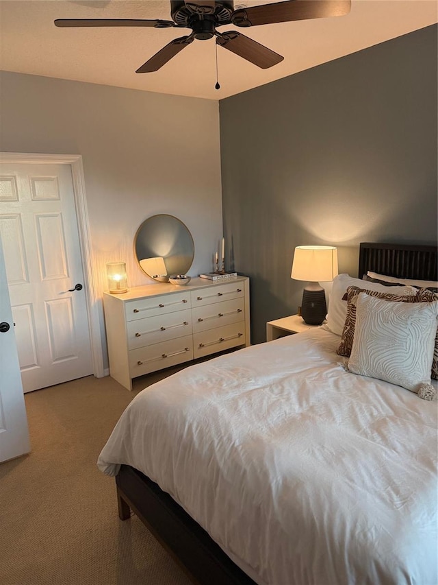 bedroom featuring light carpet and ceiling fan