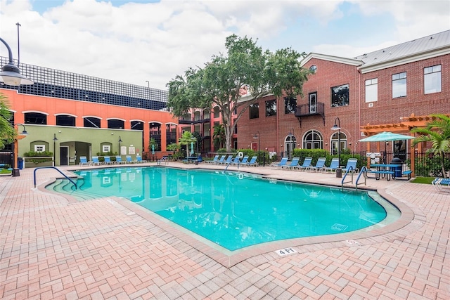 community pool featuring a patio and fence