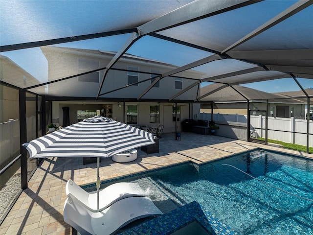 view of pool featuring a patio, glass enclosure, fence, and a fenced in pool