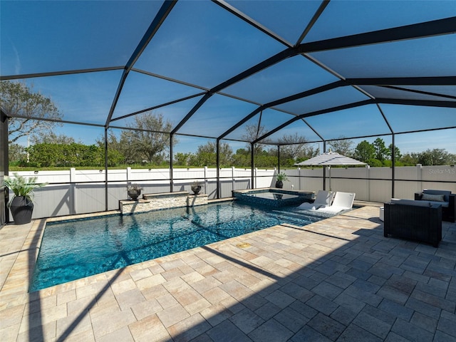 view of pool featuring a patio, a lanai, and a pool with connected hot tub