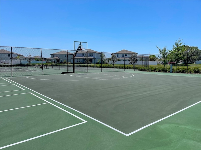 view of sport court with community basketball court, a residential view, and fence