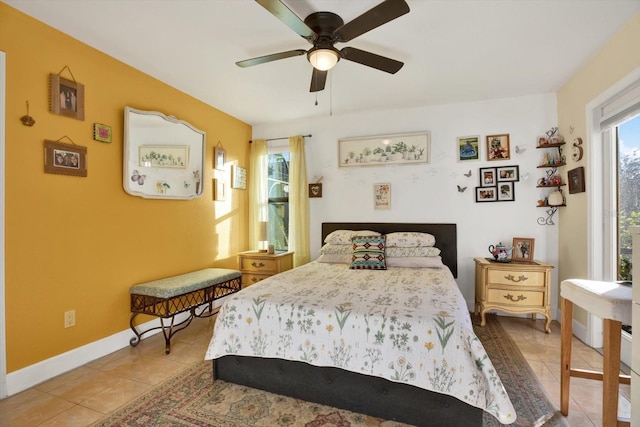 bedroom featuring tile patterned flooring, baseboards, and a ceiling fan