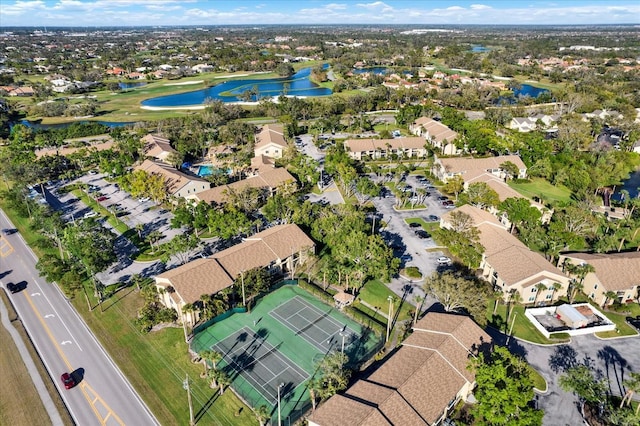 drone / aerial view featuring a water view, a residential view, and golf course view