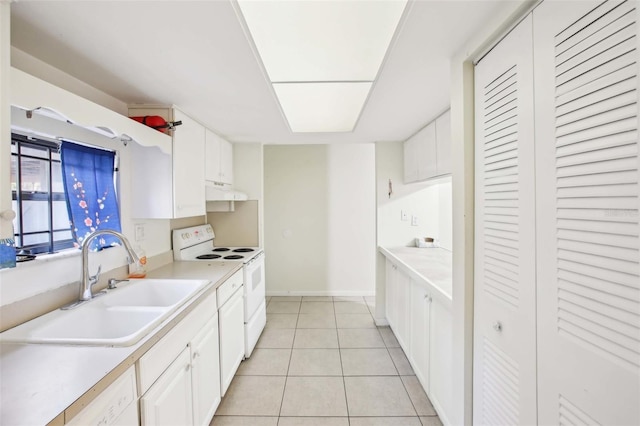 kitchen with light countertops, light tile patterned flooring, a sink, white cabinetry, and white appliances