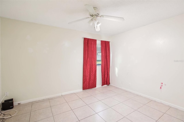 unfurnished room featuring ceiling fan and baseboards