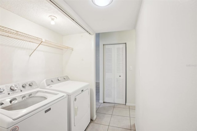 laundry room featuring laundry area, independent washer and dryer, and light tile patterned floors