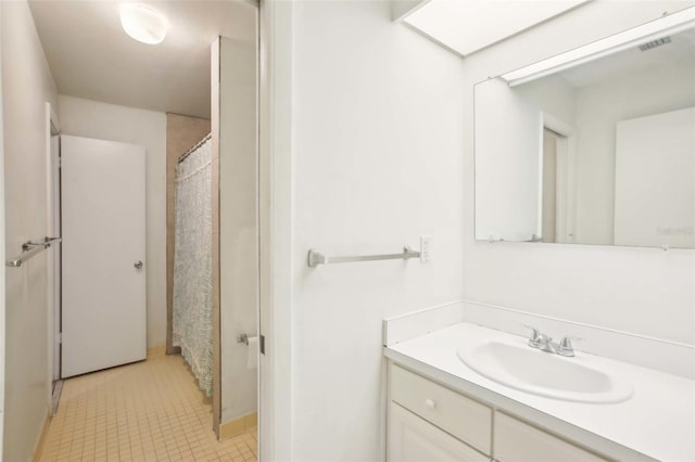 bathroom featuring vanity, visible vents, and tile patterned floors