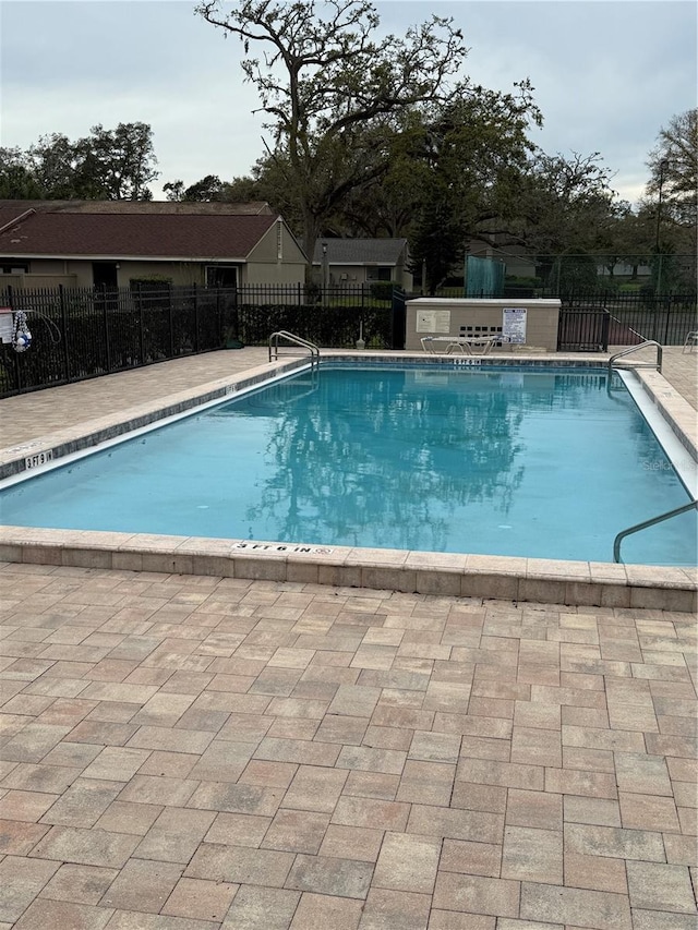 pool featuring a patio area and fence