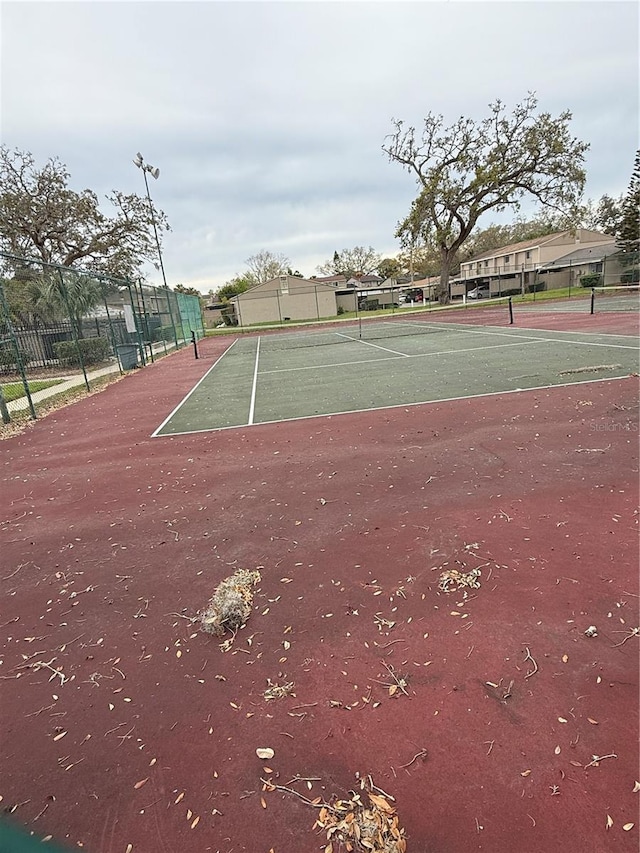 view of sport court featuring fence