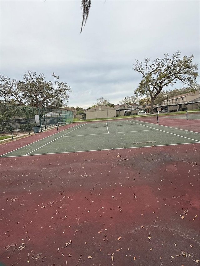 view of sport court with fence