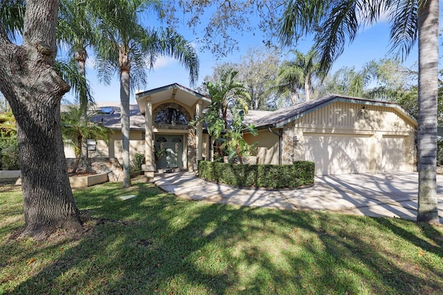 view of front facade with an attached garage, driveway, and a front yard