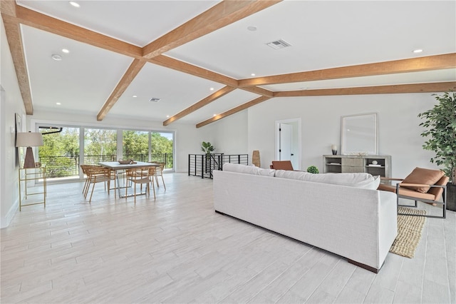 living area featuring vaulted ceiling with beams, light wood-type flooring, visible vents, and recessed lighting