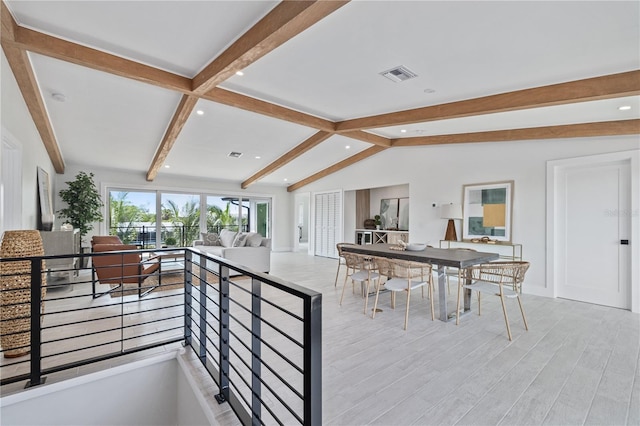 kitchen with vaulted ceiling with beams, recessed lighting, visible vents, open floor plan, and light wood finished floors