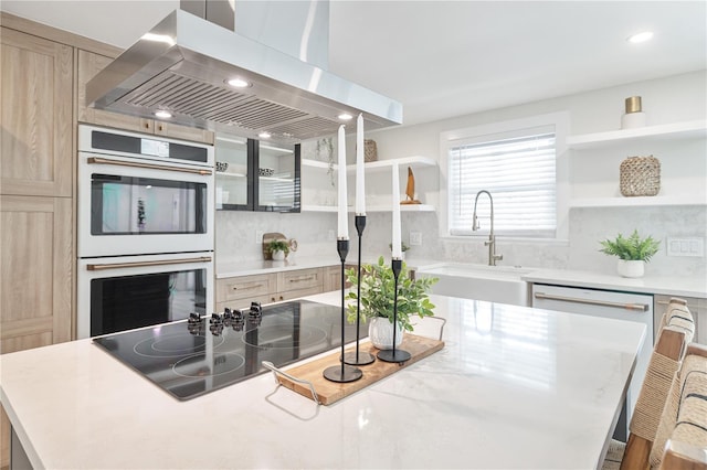 kitchen featuring double oven, black electric cooktop, a sink, range hood, and open shelves