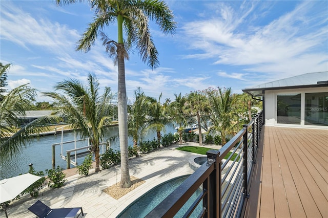 wooden terrace with a dock and a water view