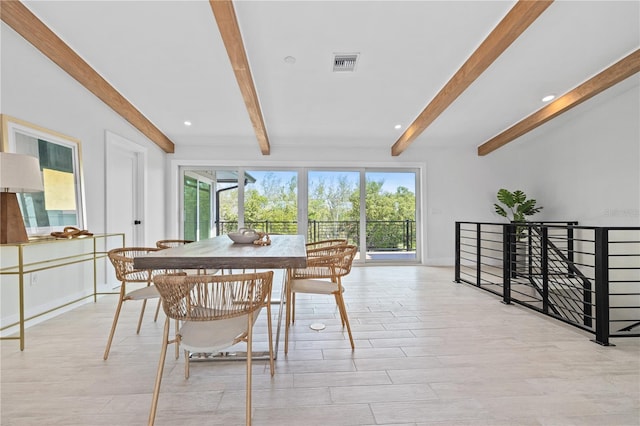 dining space featuring a healthy amount of sunlight, visible vents, and beamed ceiling