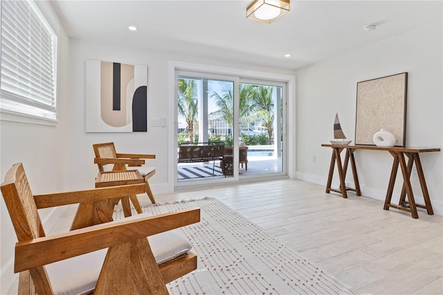 sitting room featuring recessed lighting, light wood-style flooring, and baseboards