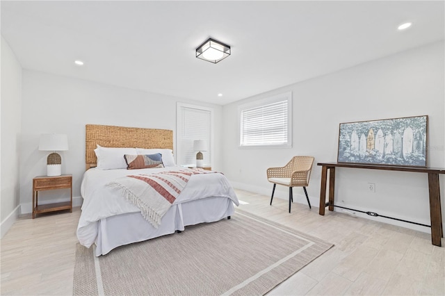 bedroom with recessed lighting, light wood-type flooring, and baseboards