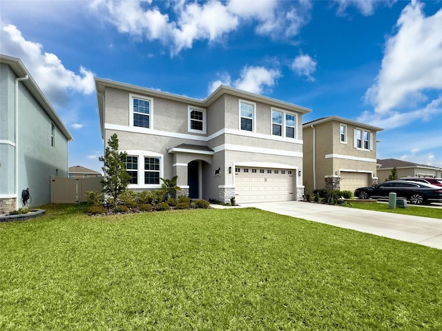 view of front facade with an attached garage, fence, concrete driveway, stucco siding, and a front yard