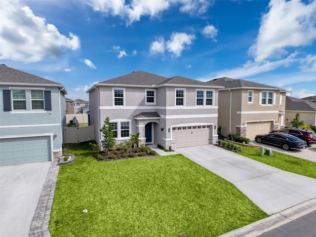 view of front of home featuring stucco siding, concrete driveway, an attached garage, fence, and a front lawn