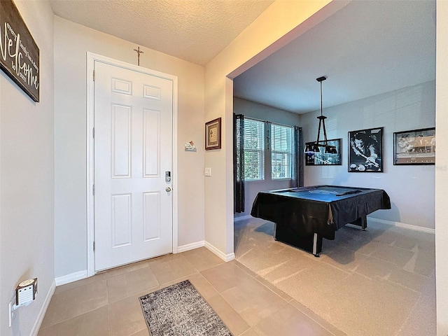 rec room featuring pool table, a textured ceiling, baseboards, and light tile patterned floors