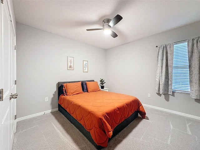 bedroom with ceiling fan, carpet floors, and baseboards