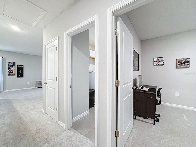 corridor featuring attic access, carpet flooring, and baseboards