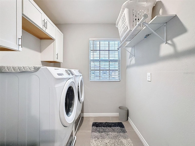 laundry area with cabinet space, light tile patterned floors, baseboards, and separate washer and dryer