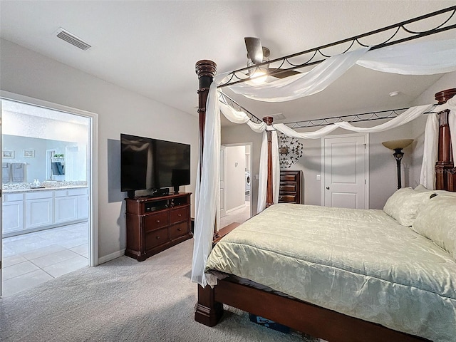 bedroom featuring light carpet, connected bathroom, and visible vents