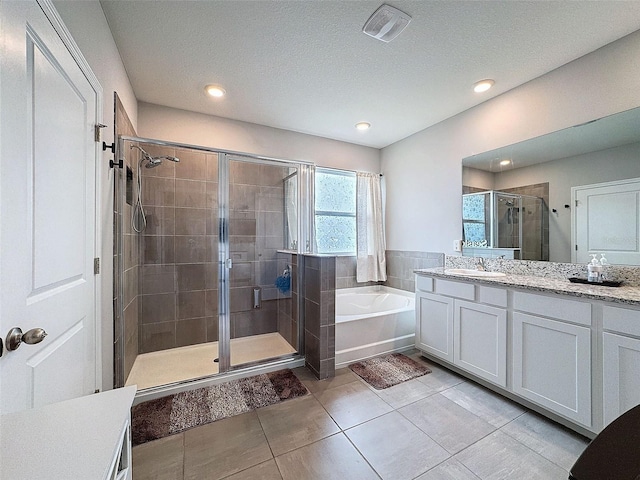 full bathroom featuring visible vents, a garden tub, tile patterned flooring, vanity, and a shower stall