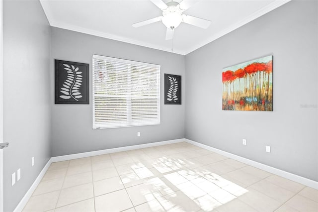 tiled empty room featuring crown molding, a ceiling fan, and baseboards