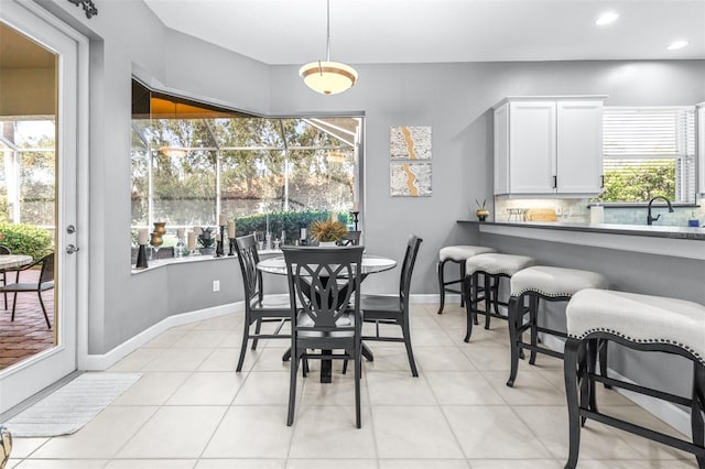 dining space featuring light tile patterned floors, baseboards, and recessed lighting