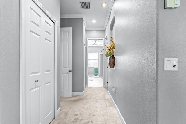 hall with visible vents, crown molding, baseboards, carpet flooring, and recessed lighting