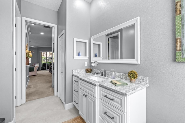 bathroom with tile patterned flooring, visible vents, vanity, and baseboards