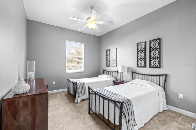 carpeted bedroom with baseboards and a ceiling fan