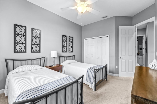 bedroom with baseboards, visible vents, ceiling fan, a closet, and light colored carpet