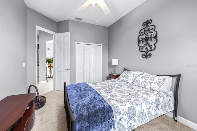 bedroom with carpet flooring, visible vents, a closet, and ceiling fan