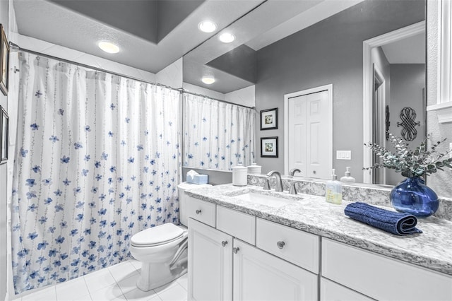 full bathroom featuring tile patterned floors, toilet, a textured ceiling, a shower with shower curtain, and vanity