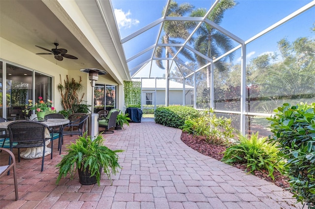 view of patio / terrace featuring glass enclosure and ceiling fan