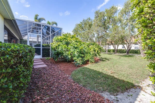 view of yard with glass enclosure