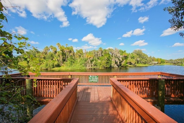 wooden terrace featuring a water view