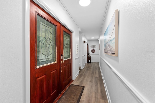 doorway to outside featuring wood finished floors and baseboards