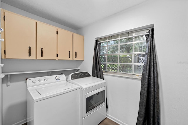 laundry room featuring baseboards, cabinet space, and washer and dryer