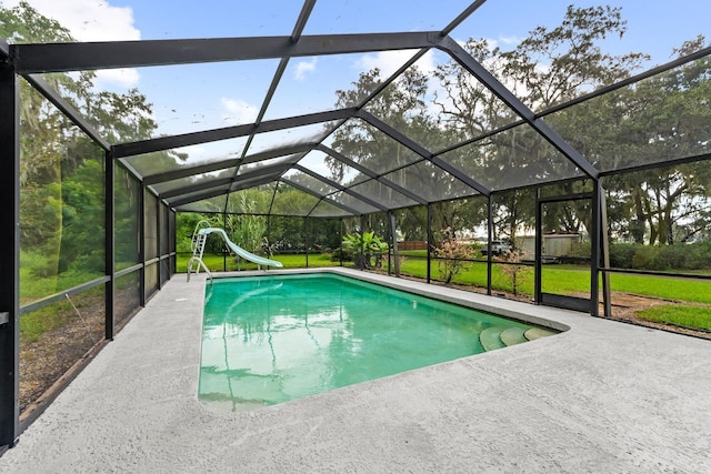 pool with a yard, a patio, a water slide, and a lanai