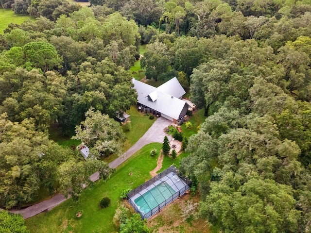 aerial view featuring a wooded view