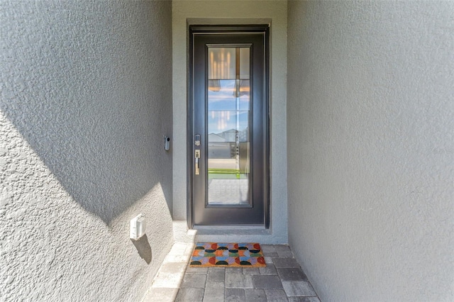 property entrance featuring stucco siding